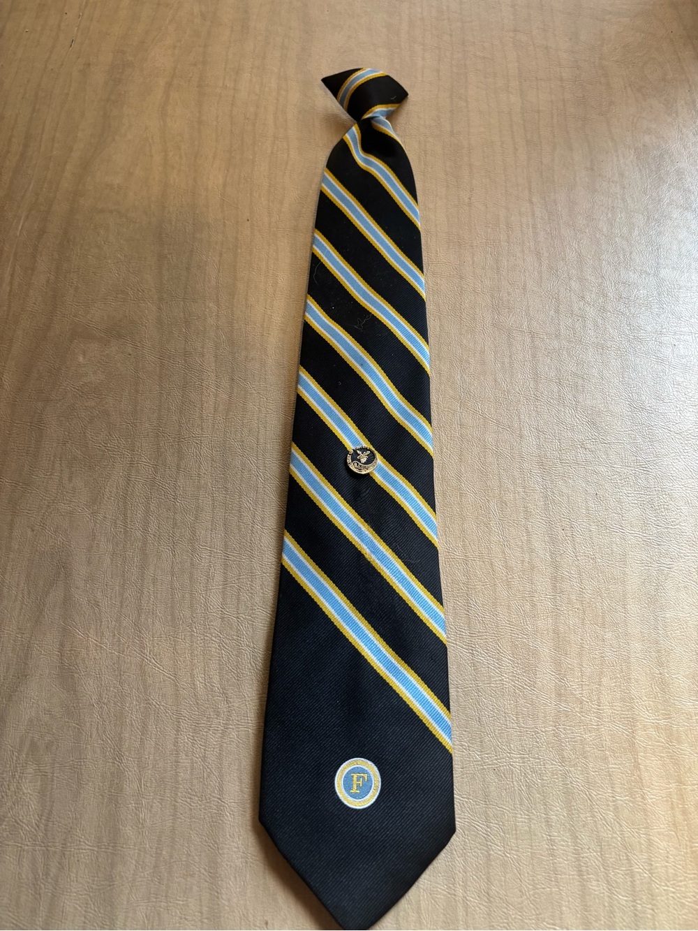 Men's Black Stripe Tie with Blue and Gold Accent Pin Attached
